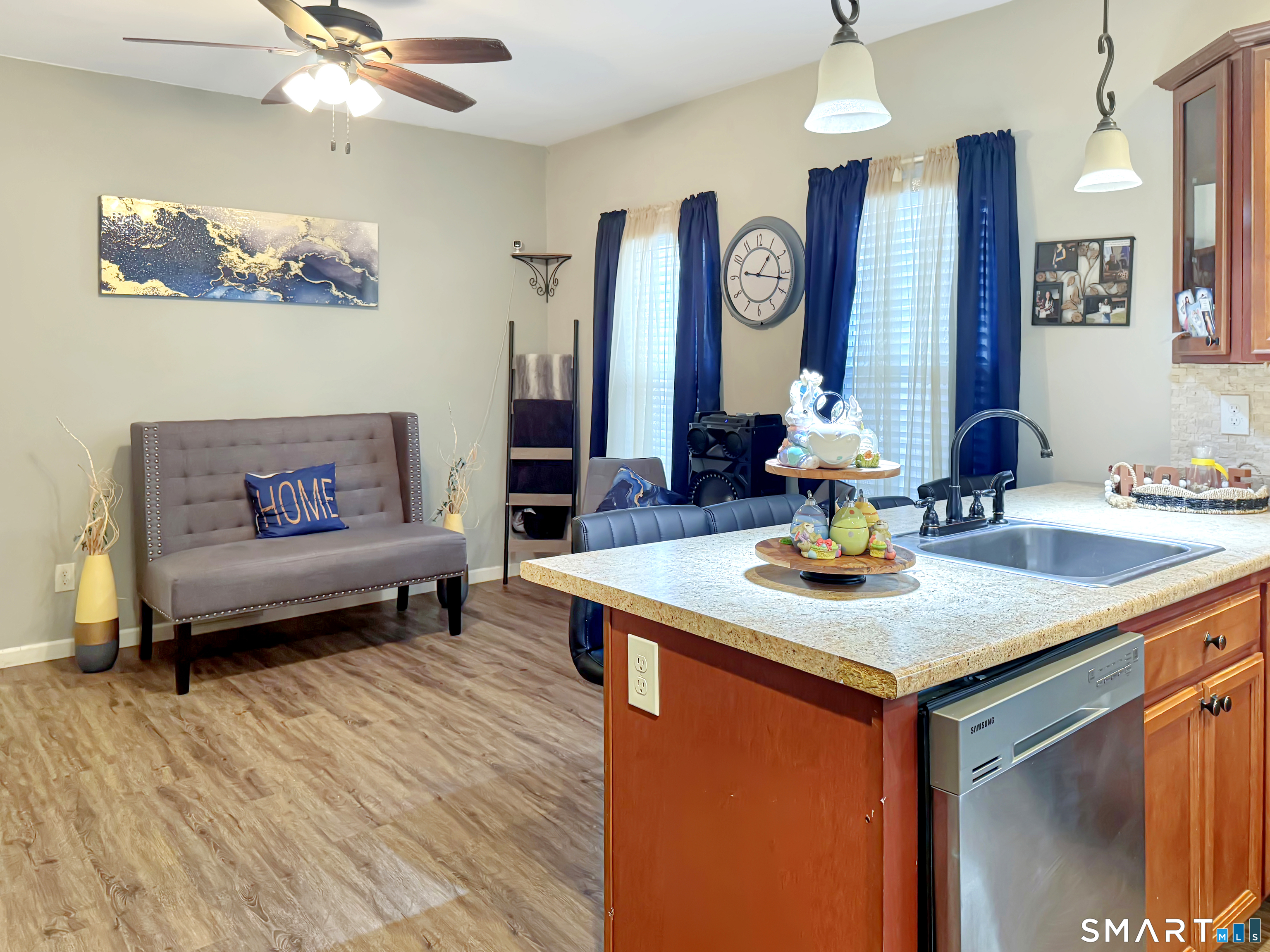 18 Columbia Street Ansonia, CT 06401 - Photo 6 of 16 a kitchen with a sink dishwasher a dining table and chairs with wooden floor