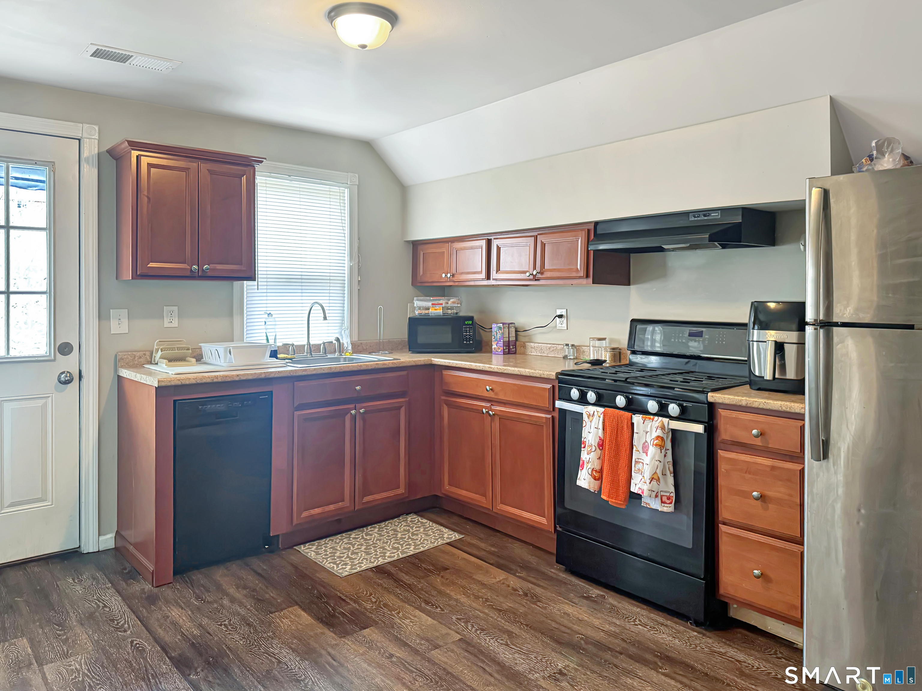18 Columbia Street Ansonia, CT 06401 - Photo 9 of 16 a kitchen with granite countertop stainless steel appliances and wooden cabinets
