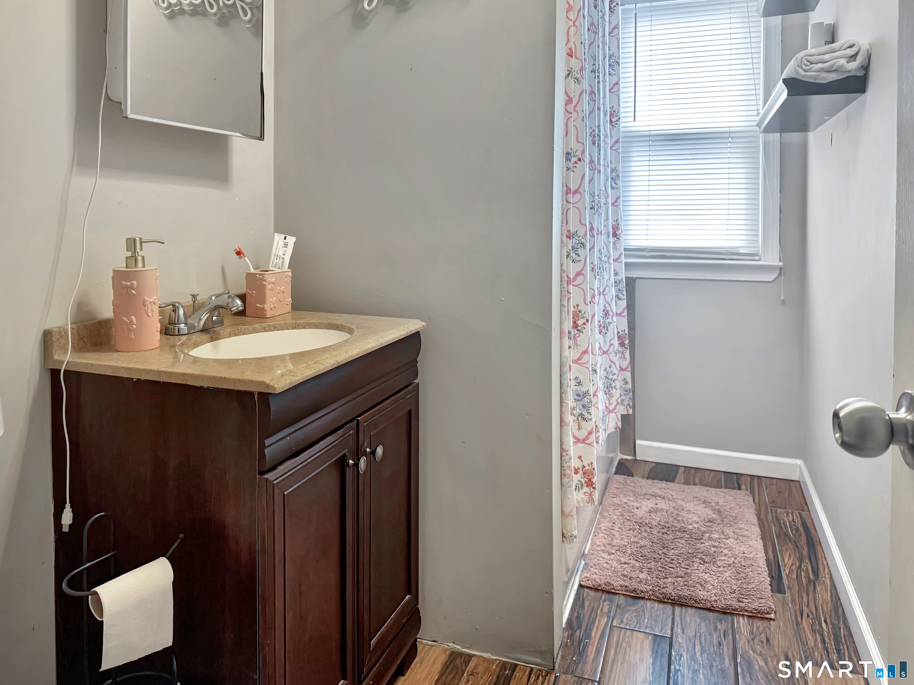 18 Columbia Street Ansonia, CT 06401 - Photo 10 of 16 a en suite bathroom with a sink a mirror and shower