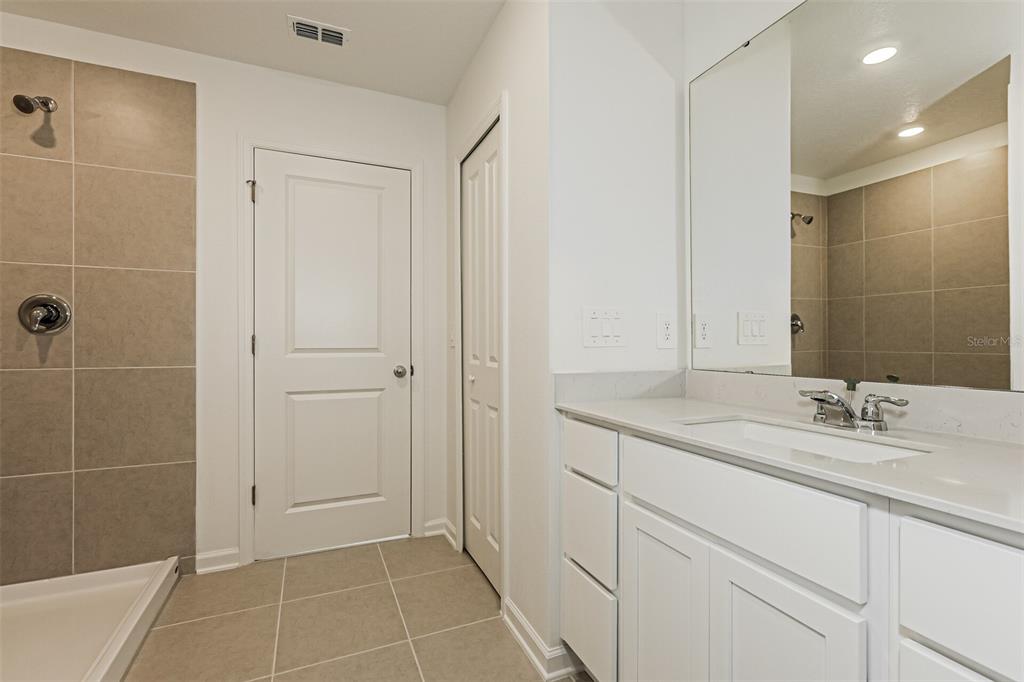 3526 Kimbrough Drive Lake Wales, FL 33853 - Photo 12 of 14 a bathroom with a granite countertop sink a shower and a mirror