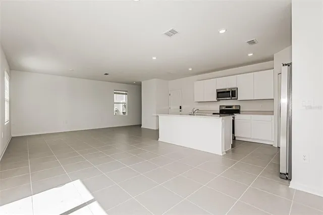 a view of a kitchen with microwave and cabinets