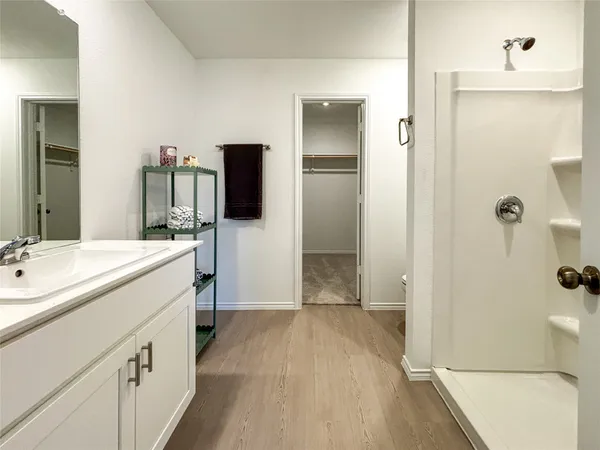 a view of cabinets with wooden floor and window