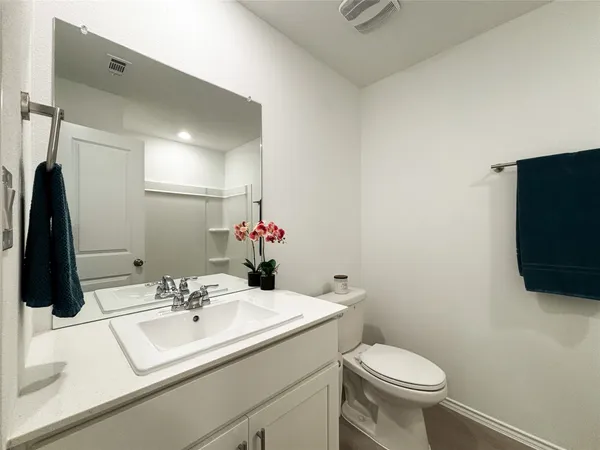 a bedroom with a bed and painting on the wall