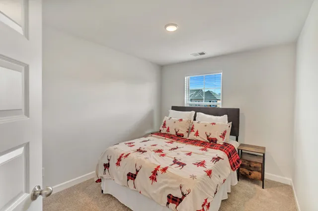 a bedroom with a bed and a painting on the wall