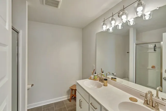 a bathroom with a sink vanity and a mirror