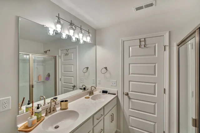 a bathroom with a sink double vanity and a mirror