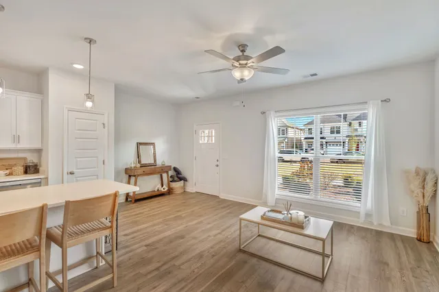 a living room with furniture and wooden floor