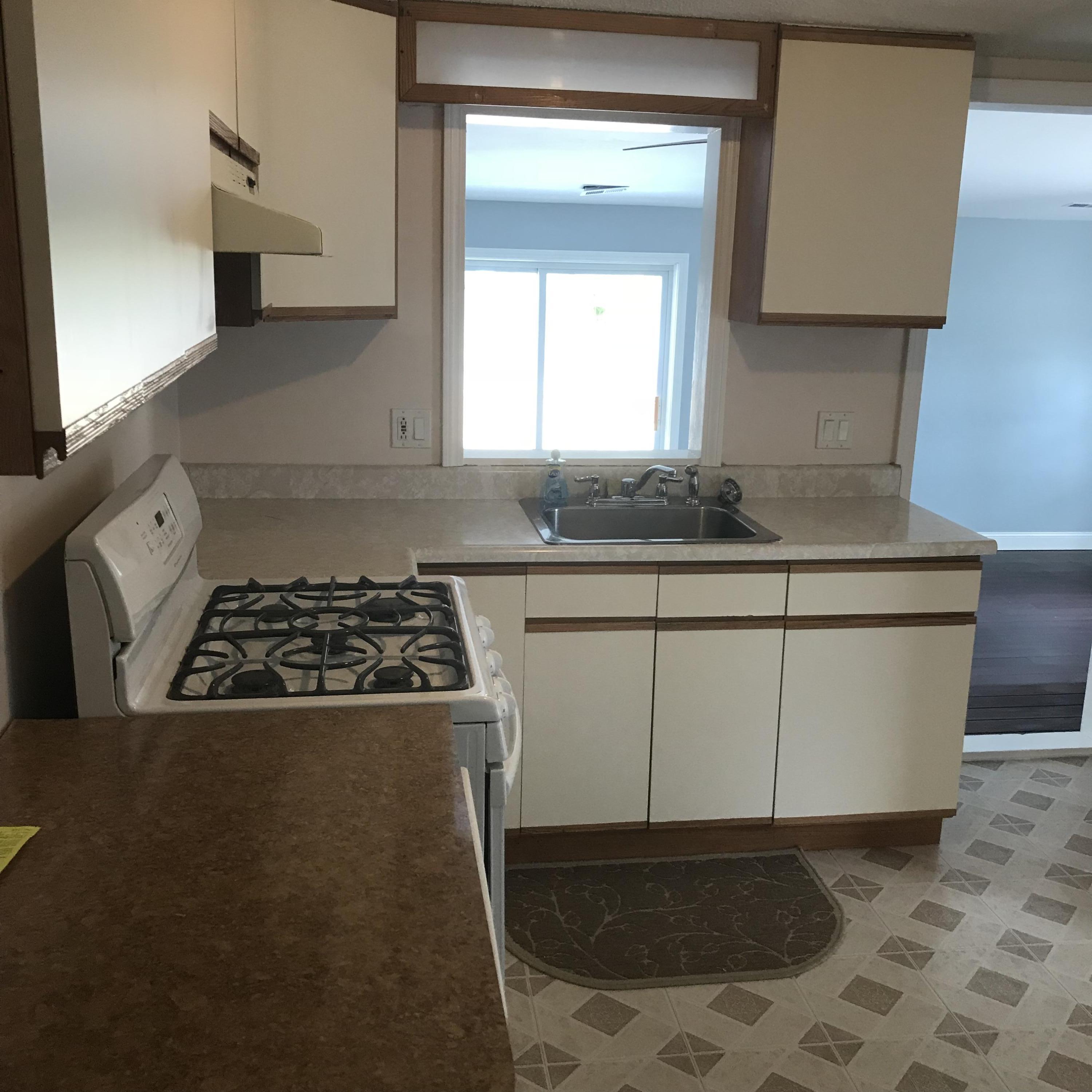 36 Somerset Road Mashpee, MA 02649 - Photo 13 of 17 a kitchen with kitchen island a stove a sink and a refrigerator