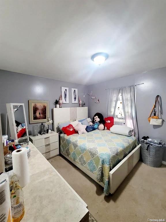 171-28 103rd Road Queens, NY 11433 - Photo 11 of 21 a bed room with bed and window