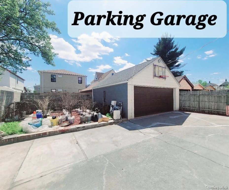 171-28 103rd Road Queens, NY 11433 - Photo 13 of 21 a view of a house with a garage