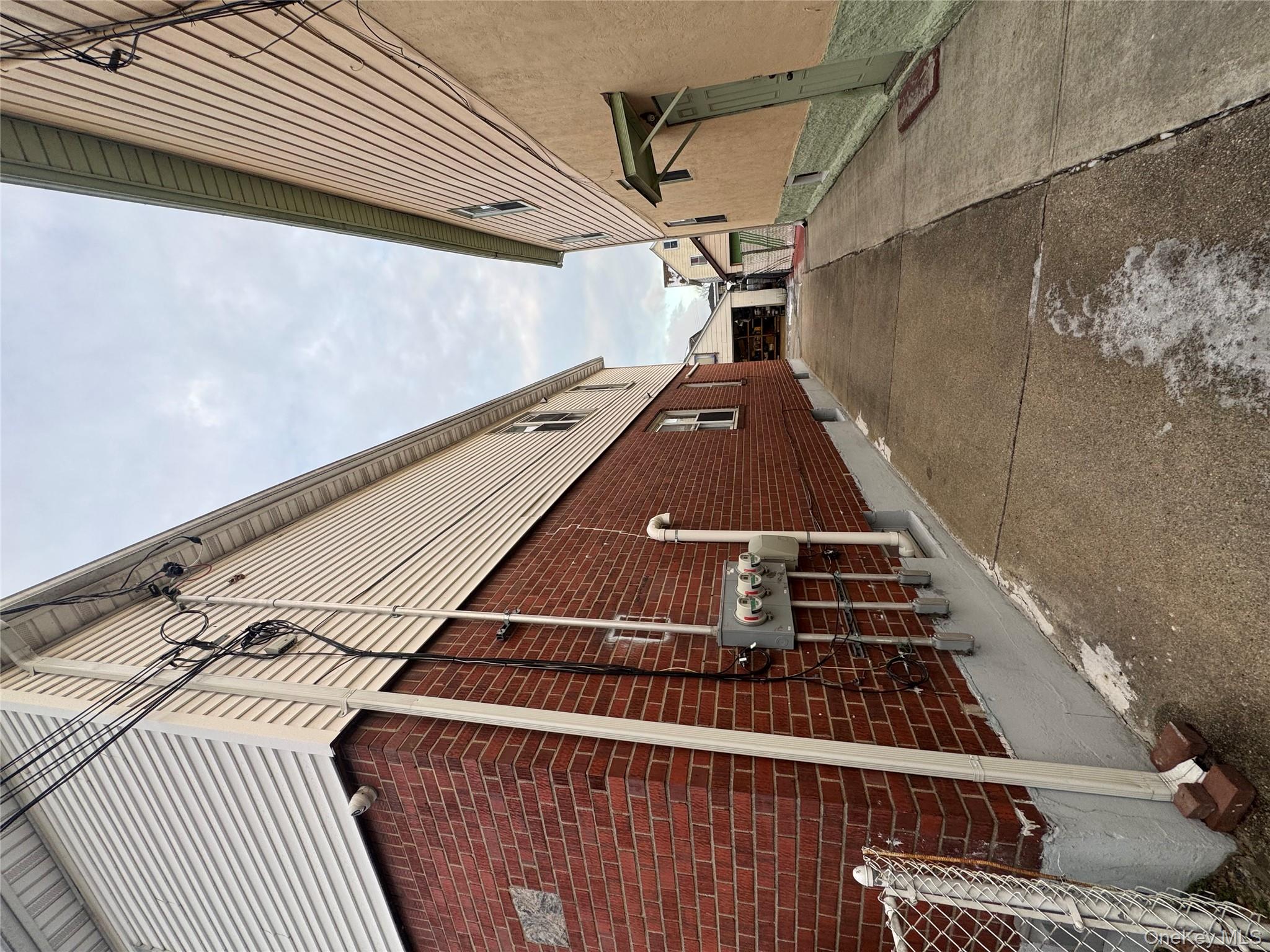 171-28 103rd Road Queens, NY 11433 - Photo 14 of 21 a backyard of a house with table and chairs