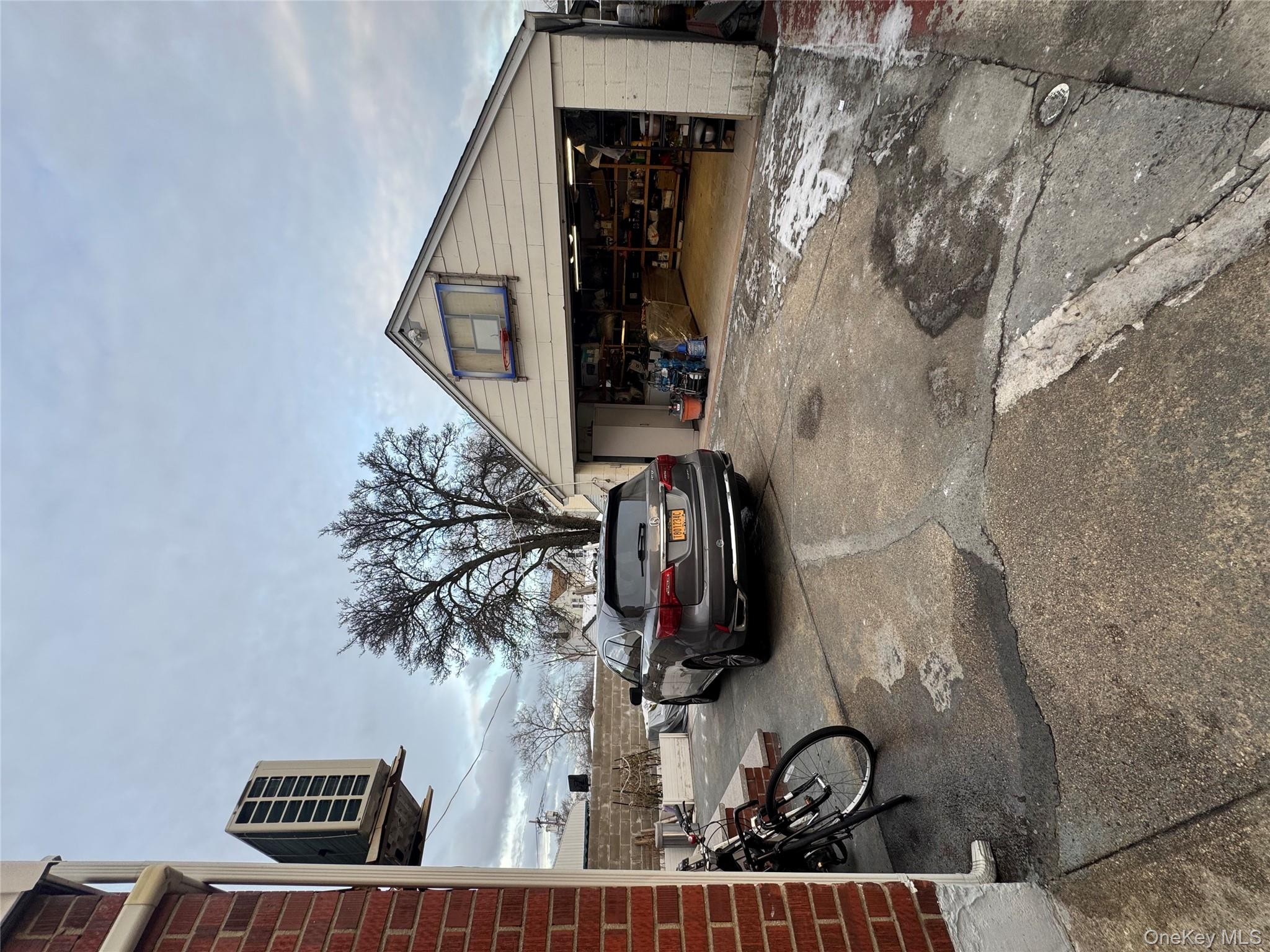 171-28 103rd Road Queens, NY 11433 - Photo 16 of 21 a front view of a house with parking area