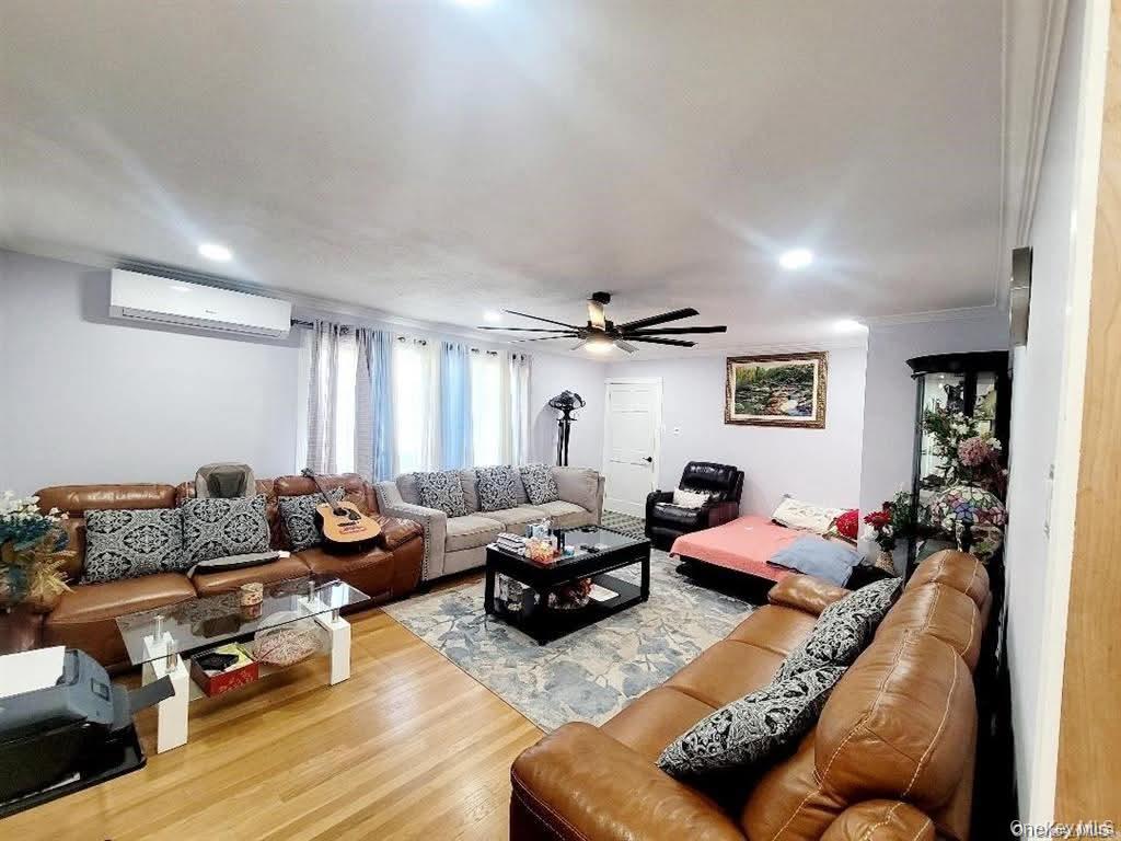 171-28 103rd Road Queens, NY 11433 - Photo 2 of 21 a living room with furniture or couch and a window