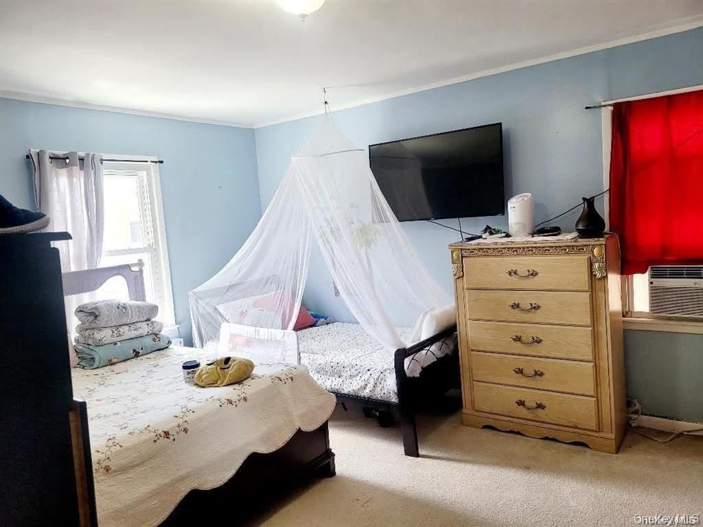 171-28 103rd Road Queens, NY 11433 - Photo 10 of 21 a bedroom with a bed and flat screen tv