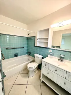 a bathroom with a double vanity sink mirror and toilet