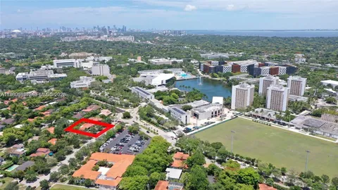 an aerial view of residential houses with outdoor space and lake view