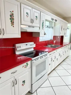 a kitchen with stainless steel appliances granite countertop a stove and a refrigerator