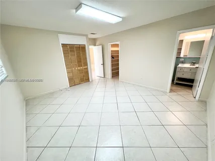 a view of a livingroom with an empty space and a window