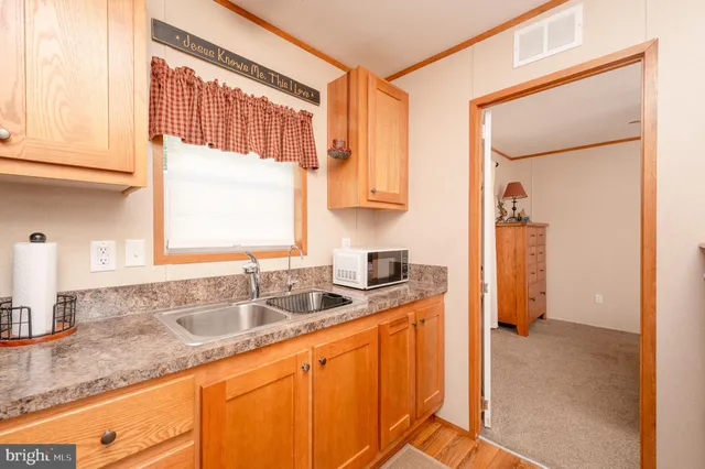 a kitchen with granite countertop a sink and a window