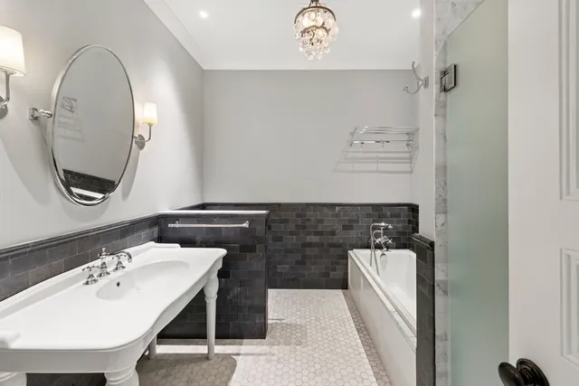 a bedroom with a bed a book shelf and a window