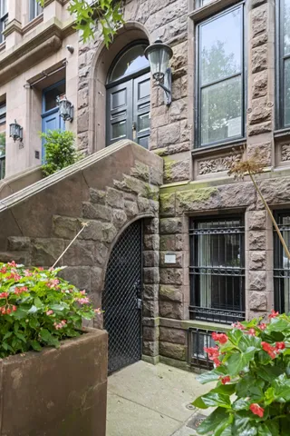 a bedroom with a bed and a potted plant