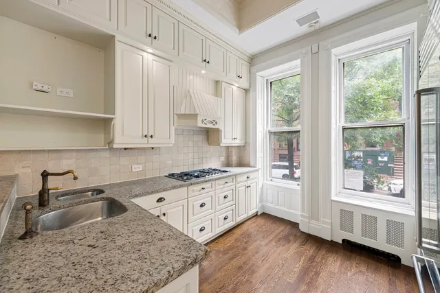 a large white kitchen with a large window
