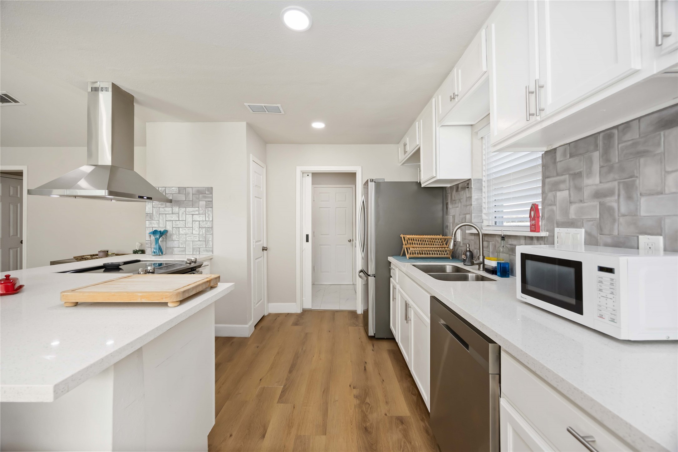12119 Spring Grove Drive Houston, TX 77099 - Photo 11 of 30 a kitchen with a sink a stove and cabinets