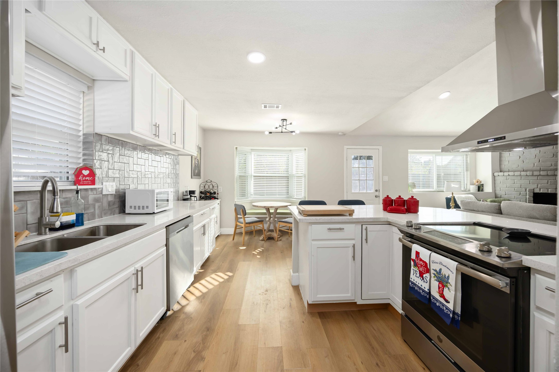 12119 Spring Grove Drive Houston, TX 77099 - Photo 12 of 30 a kitchen that has a lot of cabinets in it and wooden floors