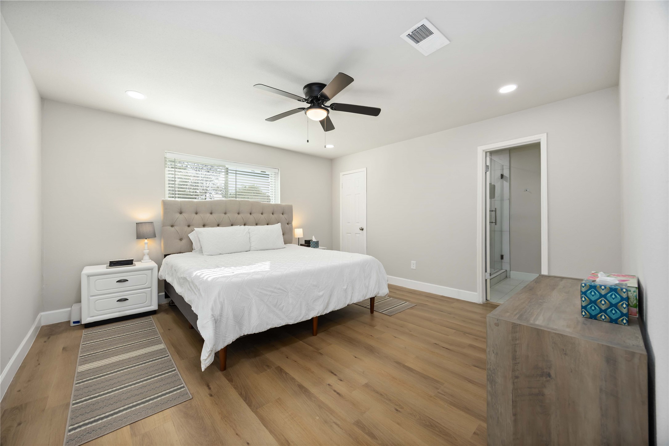 12119 Spring Grove Drive Houston, TX 77099 - Photo 14 of 30 a bedroom with a bed and a chandelier