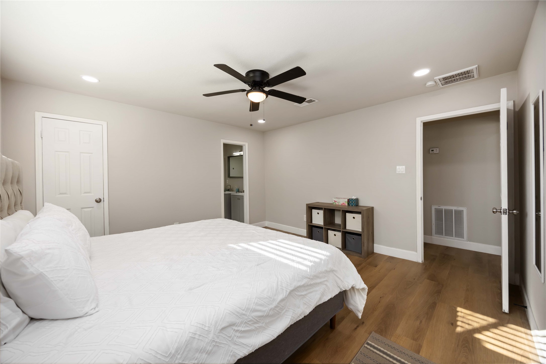 12119 Spring Grove Drive Houston, TX 77099 - Photo 15 of 30 a bedroom with a bed and a table with wooden floor