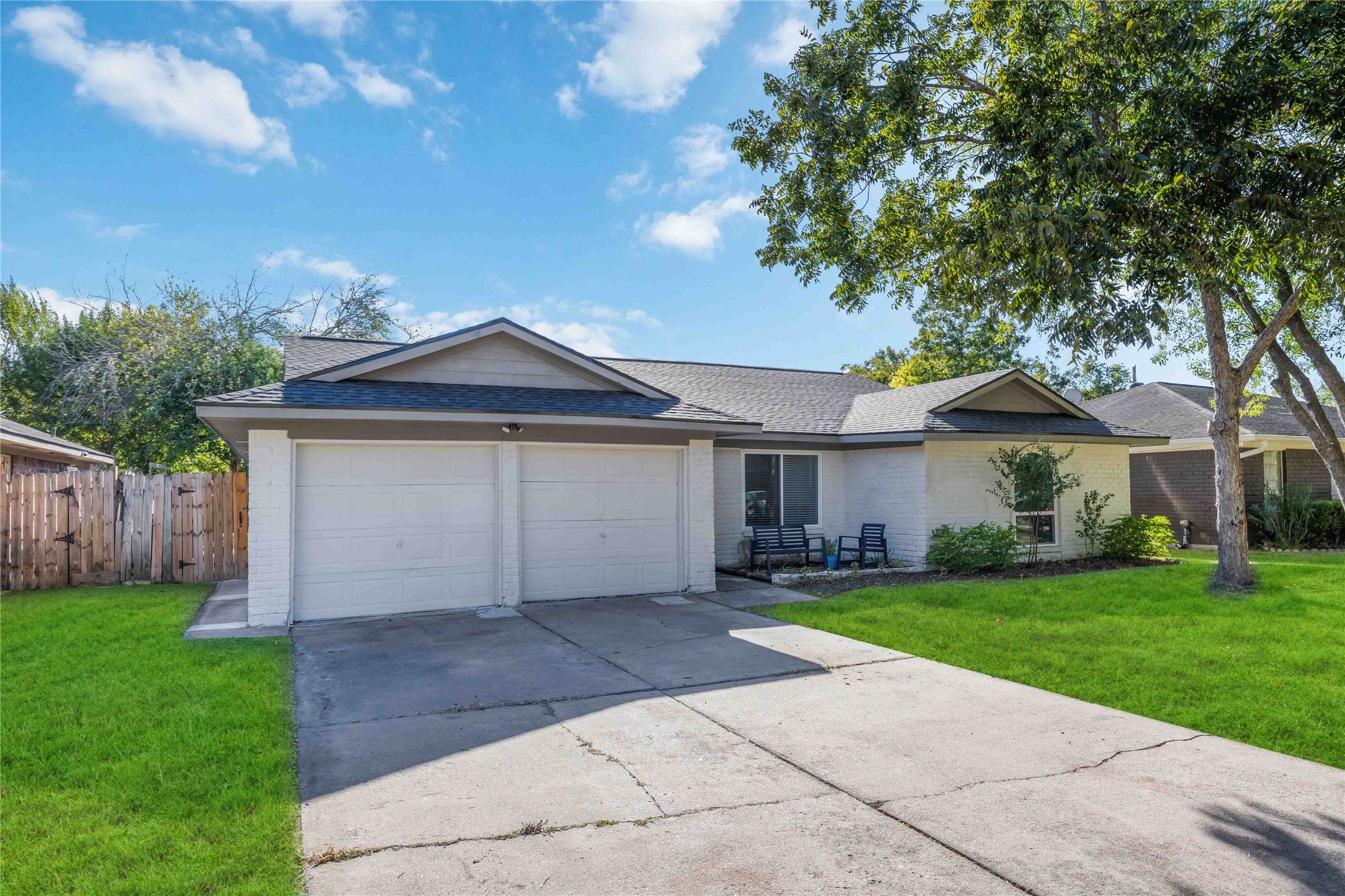 12119 Spring Grove Drive Houston, TX 77099 - Photo 2 of 30 a front view of a house with a yard and garage