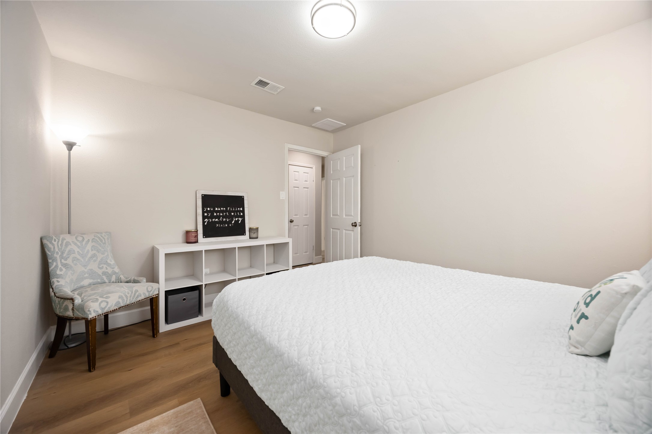 12119 Spring Grove Drive Houston, TX 77099 - Photo 20 of 30 a bedroom with a bed and a chair