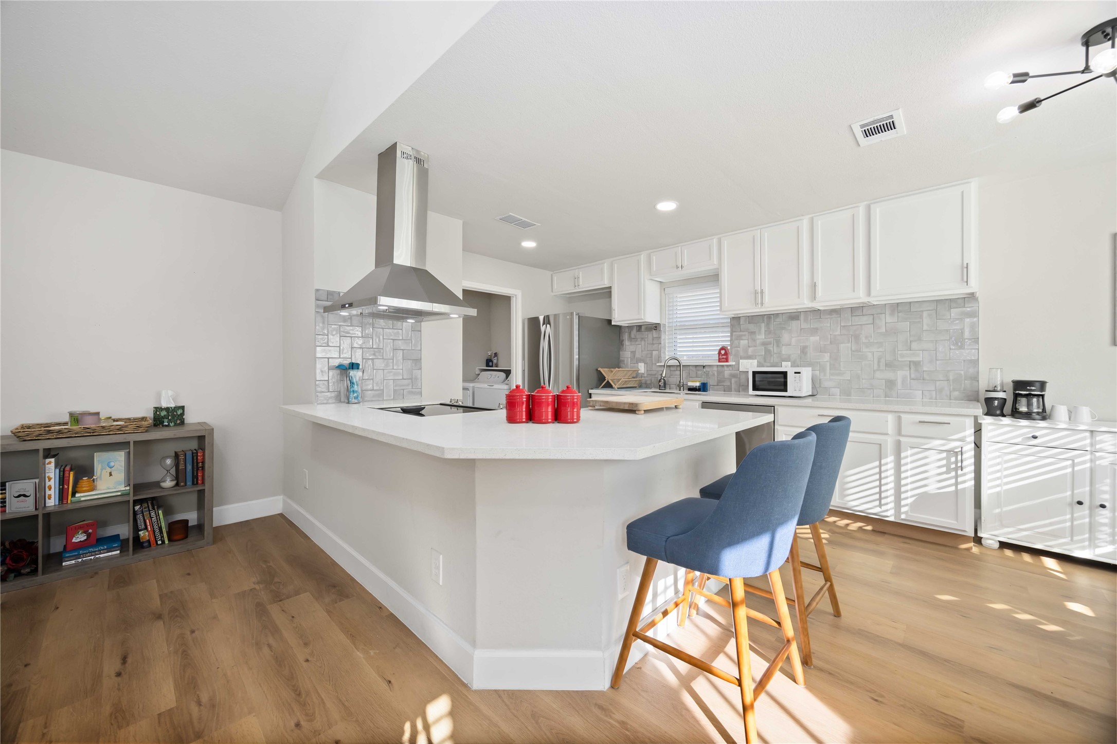 12119 Spring Grove Drive Houston, TX 77099 - Photo 10 of 30 a kitchen with a dining table chairs and white cabinets