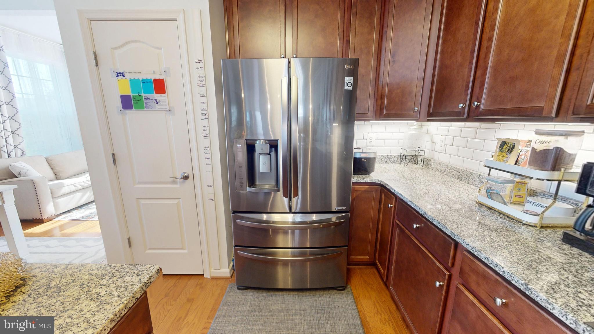 8548 Golden Eagle Lane Severn, MD 21144 - Photo 15 of 76 a kitchen with stainless steel appliances granite countertop a refrigerator and a sink