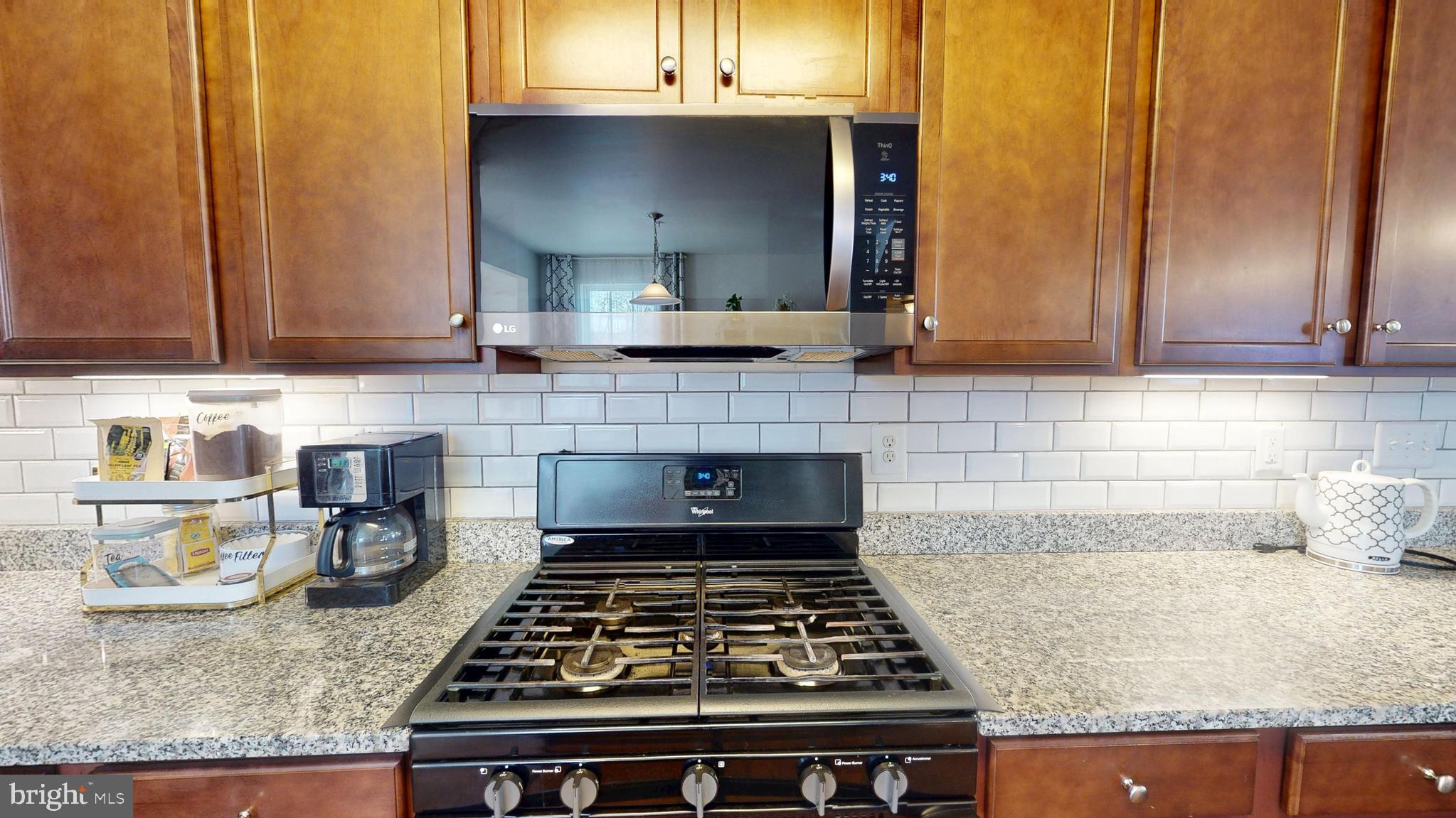 8548 Golden Eagle Lane Severn, MD 21144 - Photo 16 of 76 a kitchen with granite countertop a stove a sink and a granite counter tops
