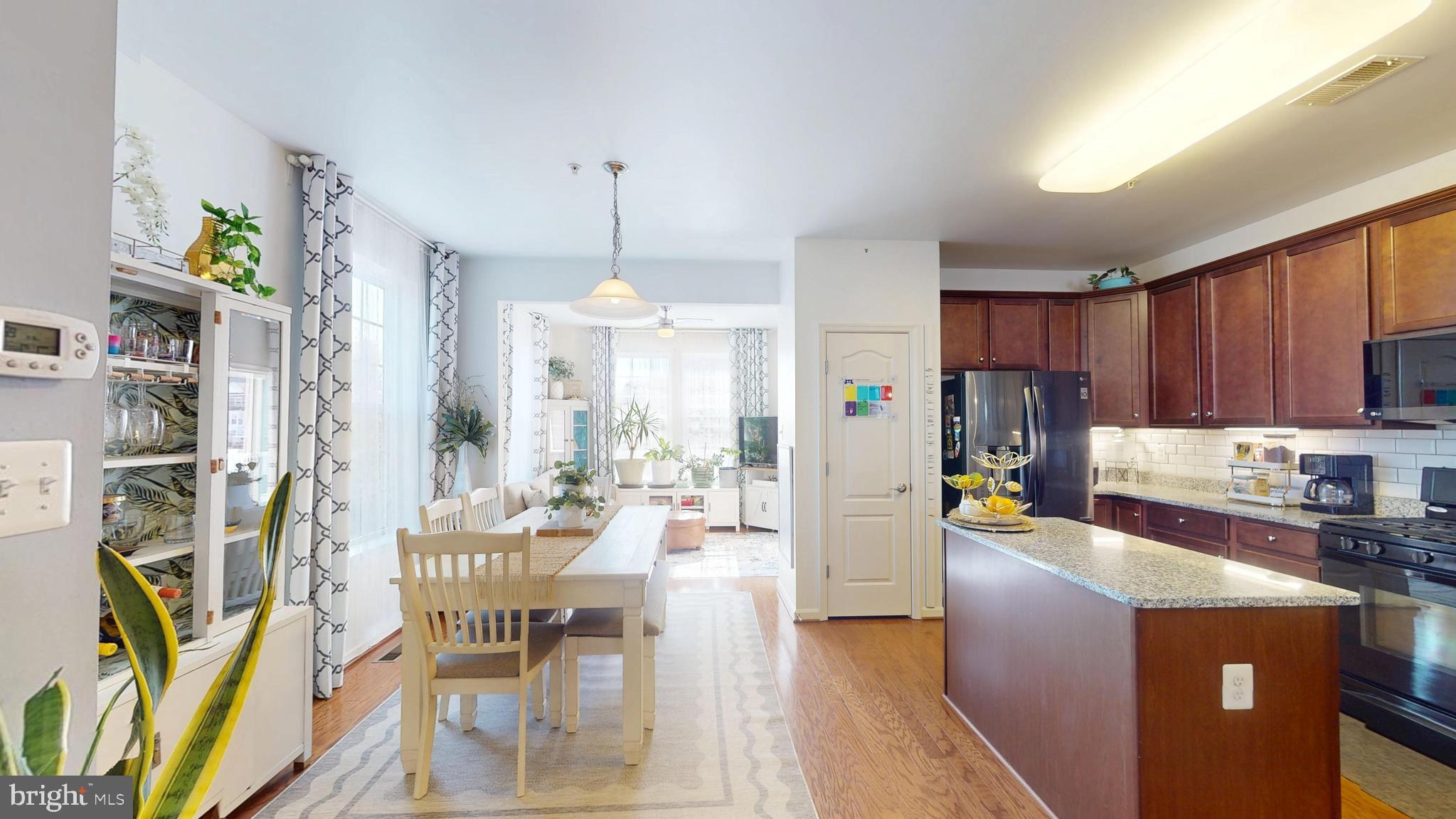8548 Golden Eagle Lane Severn, MD 21144 - Photo 22 of 76 a living room with stainless steel appliances kitchen island granite countertop furniture and a view of kitchen