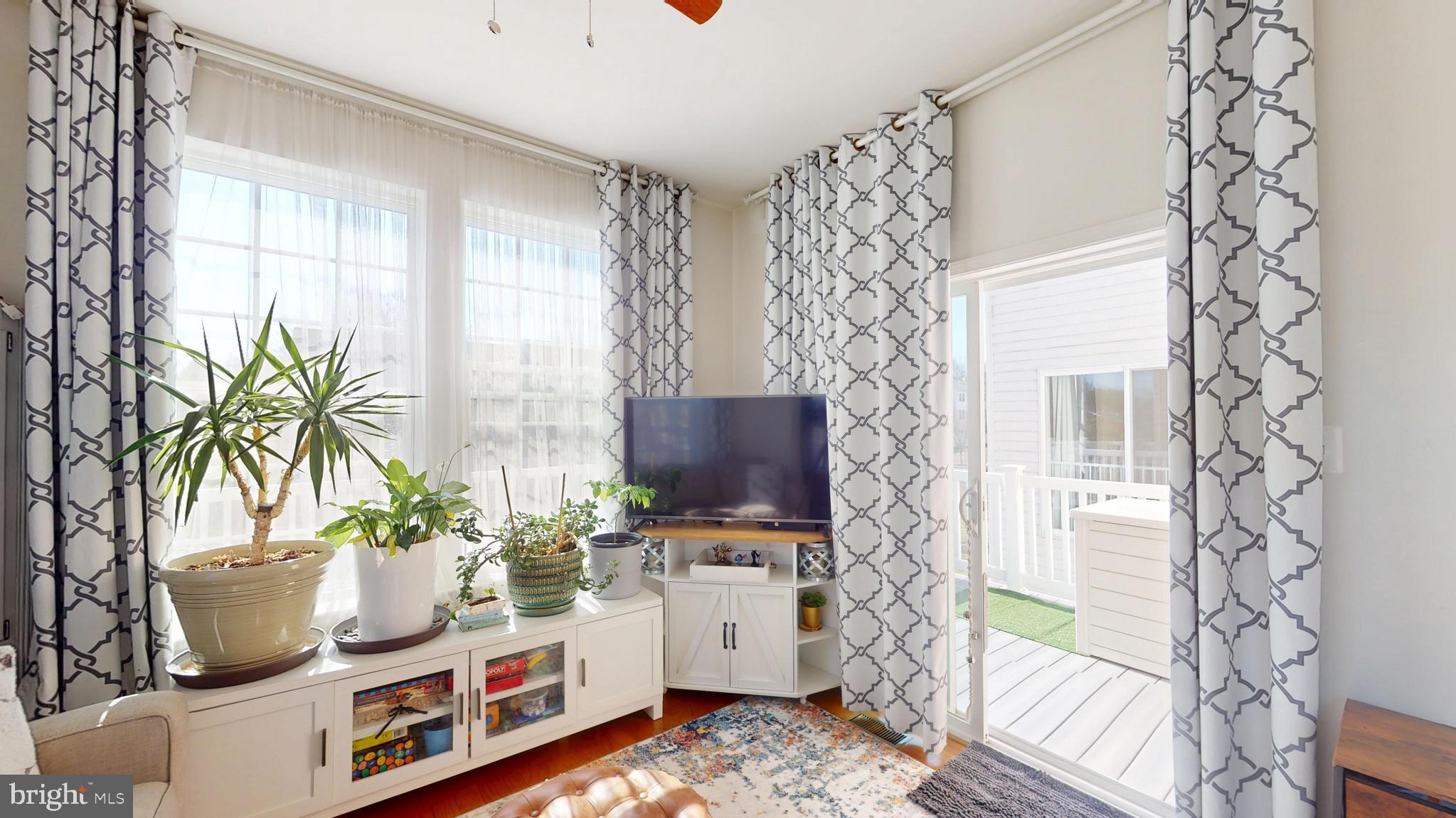 8548 Golden Eagle Lane Severn, MD 21144 - Photo 24 of 76 a living room with furniture and a potted plant