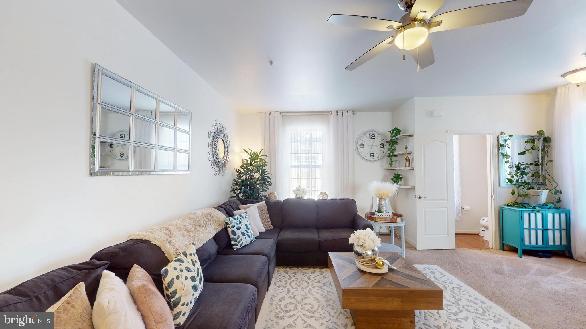 8548 Golden Eagle Lane Severn, MD 21144 - Photo 28 of 76 a living room with furniture flowerpot and a window