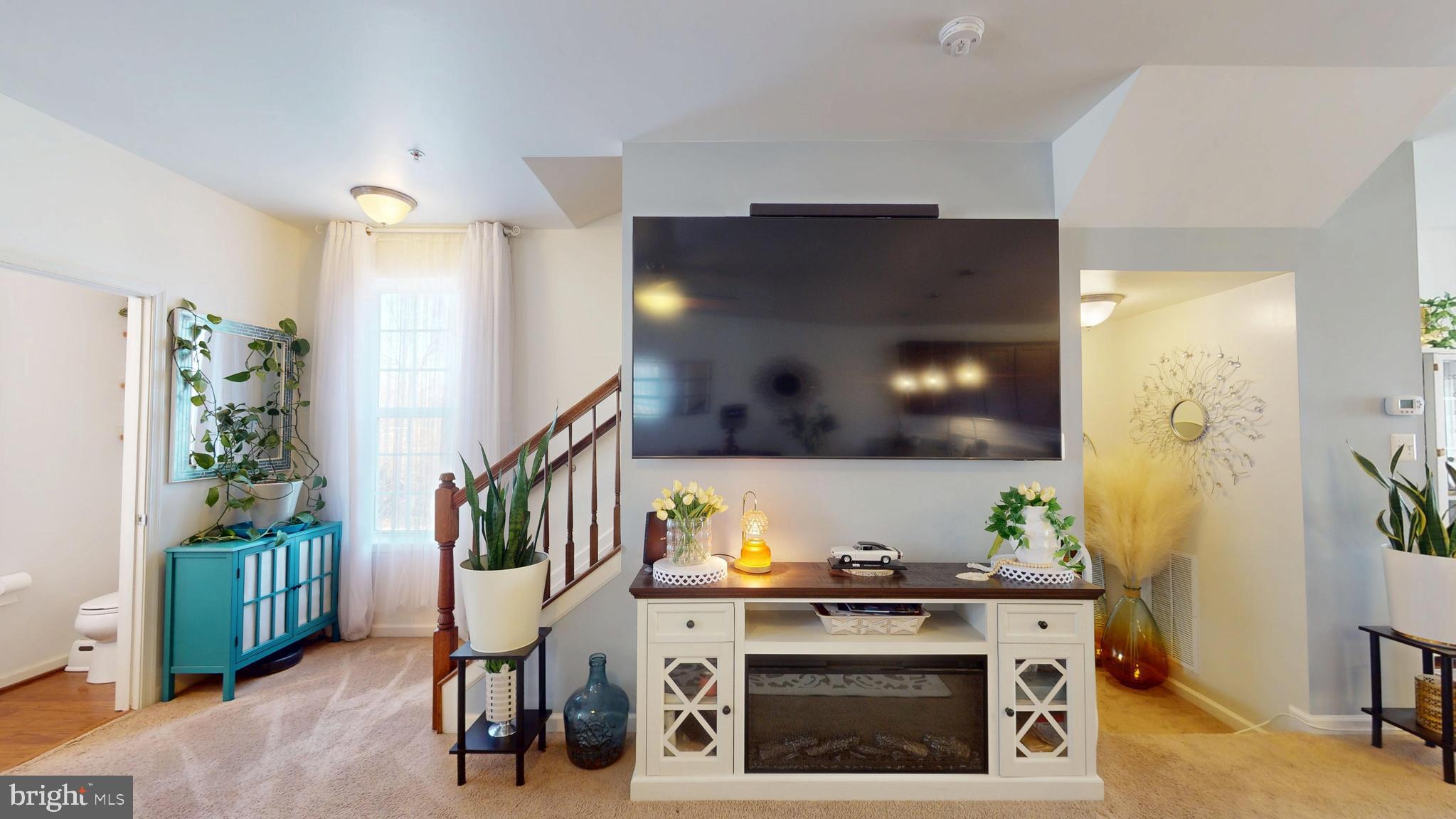 8548 Golden Eagle Lane Severn, MD 21144 - Photo 30 of 76 a living room with furniture and a fireplace