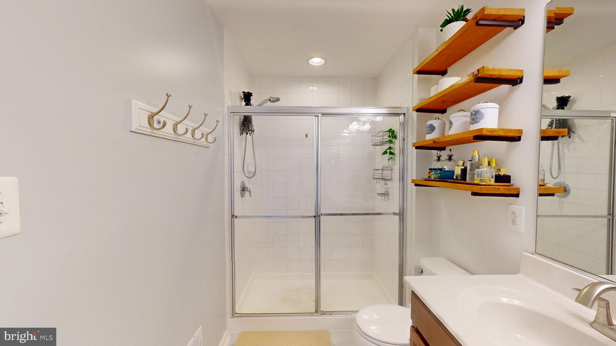 8548 Golden Eagle Lane Severn, MD 21144 - Photo 44 of 76 a bathroom with a toilet and a shower