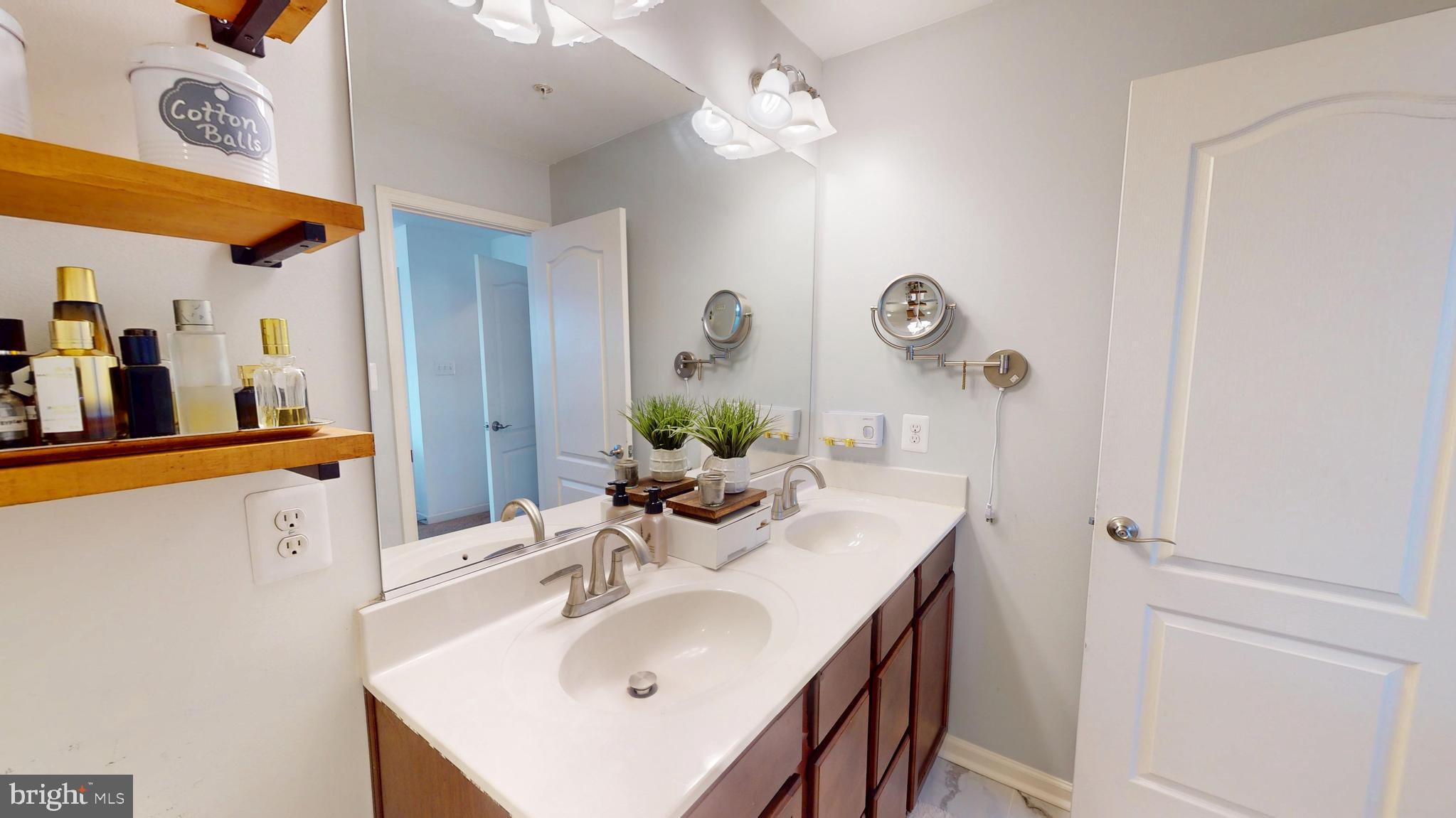 8548 Golden Eagle Lane Severn, MD 21144 - Photo 45 of 76 a bathroom with a sink a light fixture and a mirror