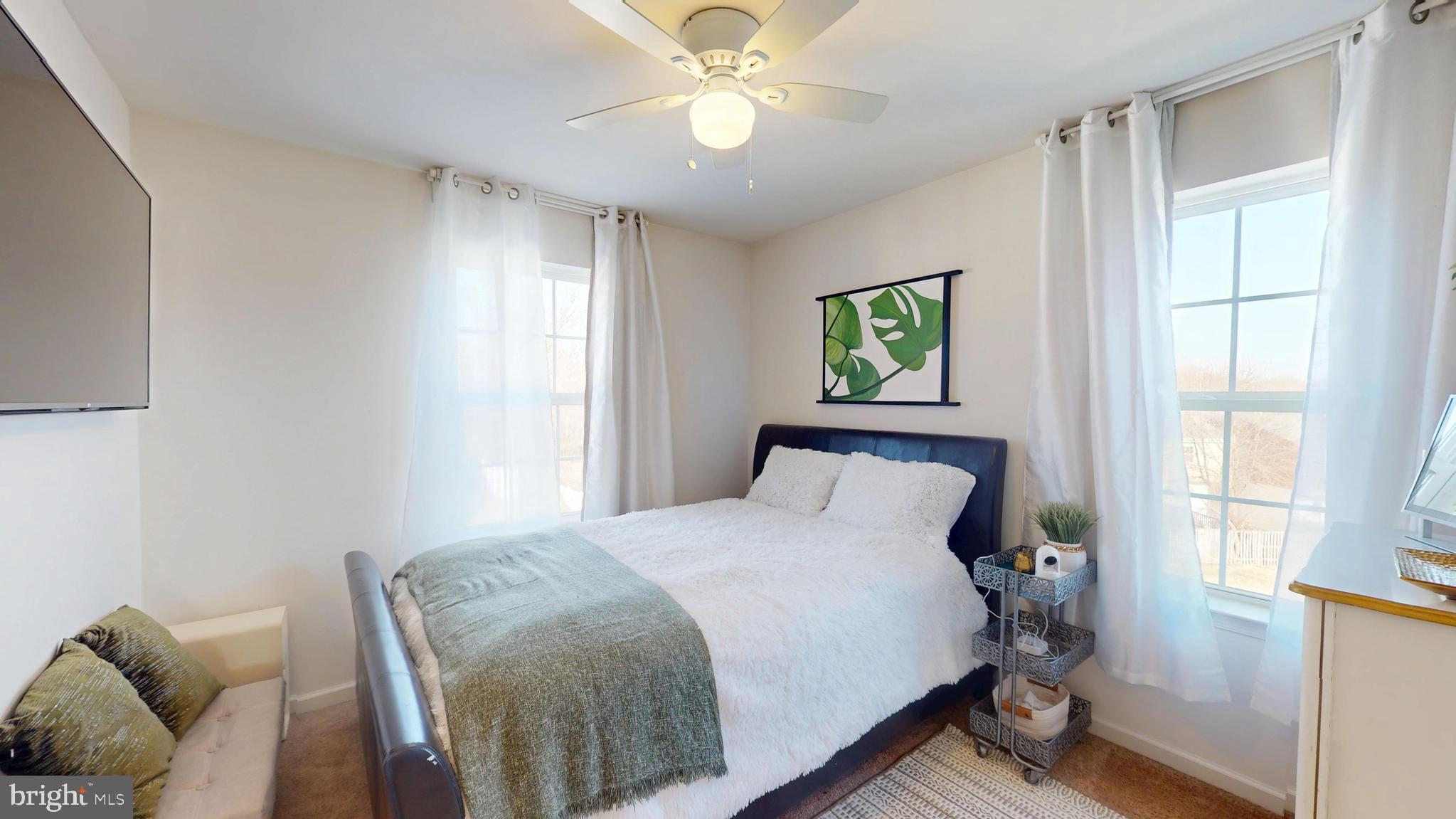 8548 Golden Eagle Lane Severn, MD 21144 - Photo 46 of 76 a bedroom with a bed and a chandelier