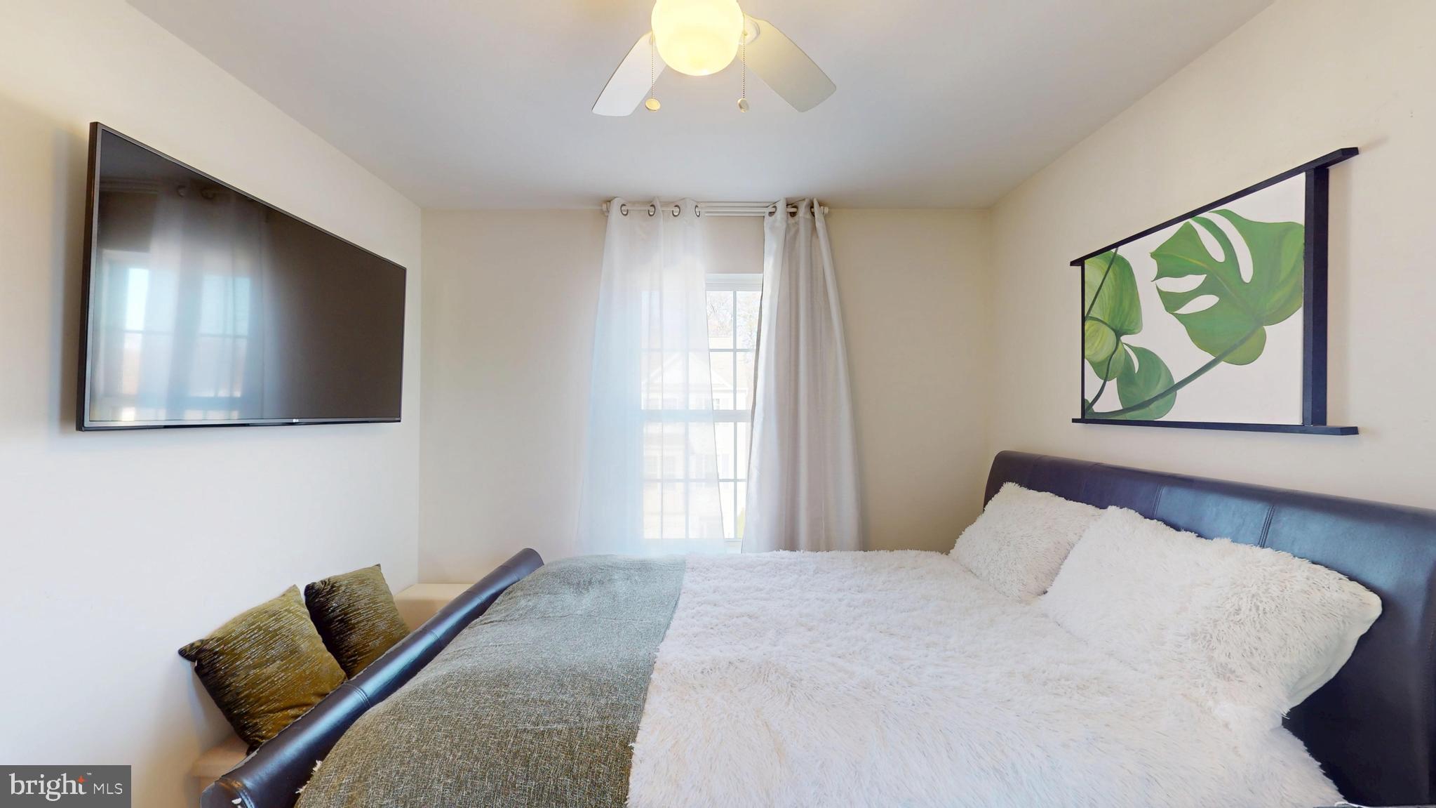 8548 Golden Eagle Lane Severn, MD 21144 - Photo 47 of 76 a bedroom with a bed and a painting on the wall