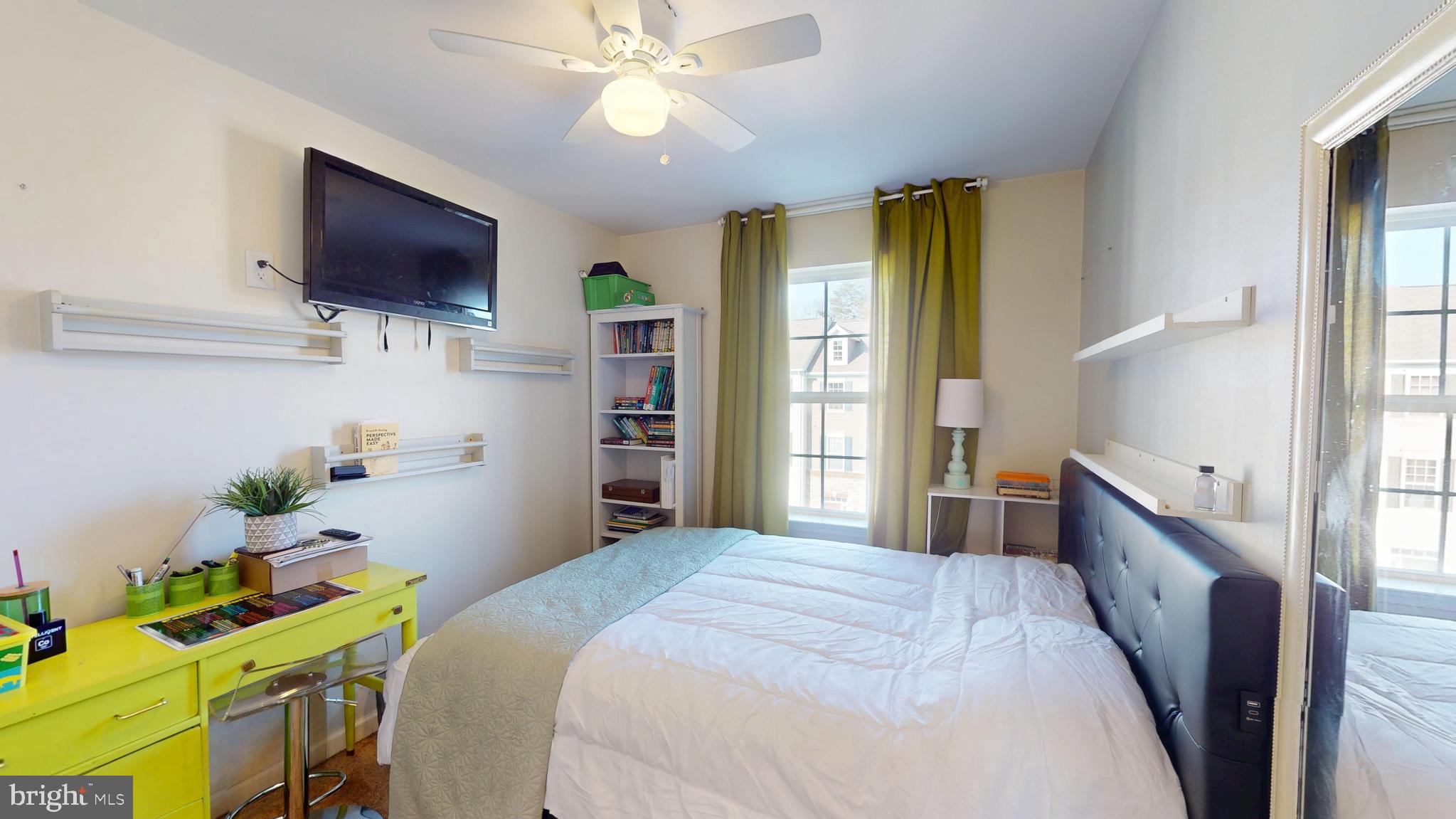 8548 Golden Eagle Lane Severn, MD 21144 - Photo 52 of 76 a bedroom with a bed and a flat screen tv