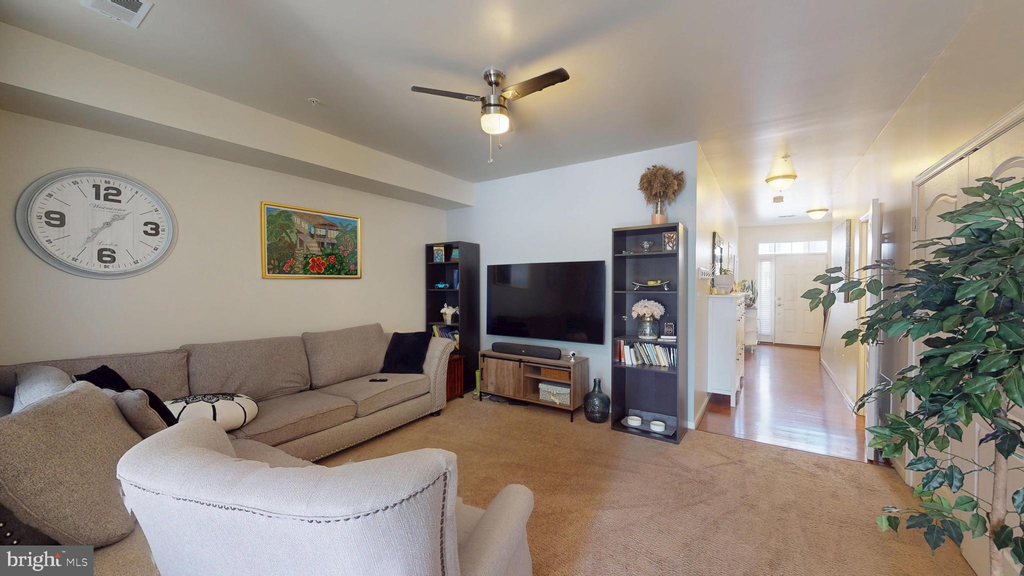 8548 Golden Eagle Lane Severn, MD 21144 - Photo 59 of 76 a living room with furniture and a flat screen tv