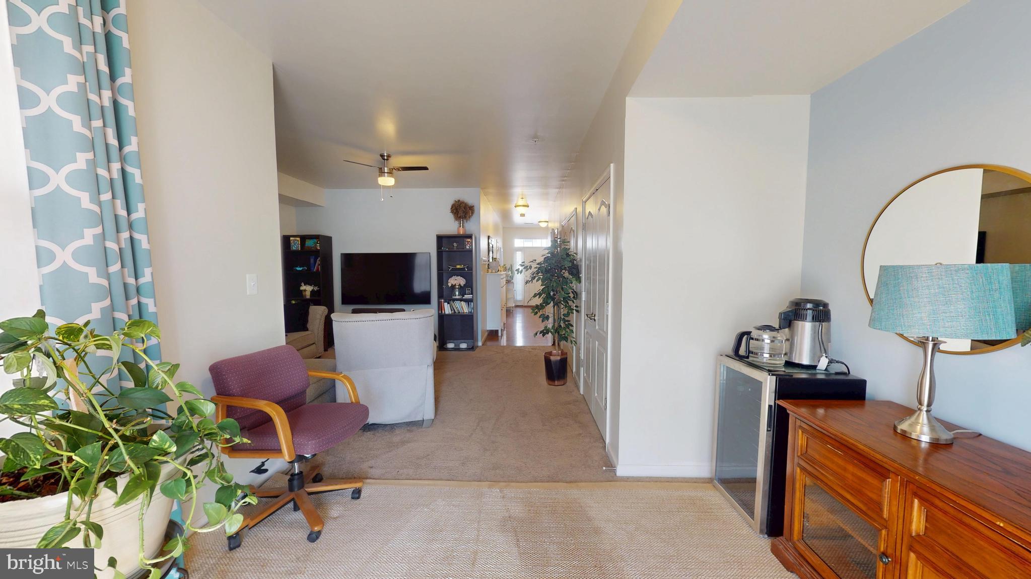 8548 Golden Eagle Lane Severn, MD 21144 - Photo 63 of 76 a living room with furniture and a flat screen tv