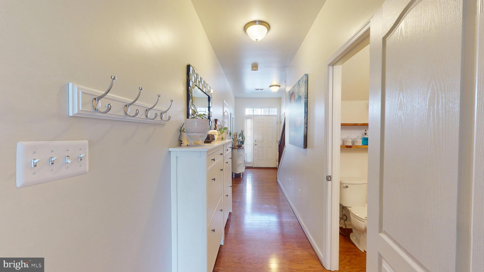 8548 Golden Eagle Lane Severn, MD 21144 - Photo 65 of 76 a view of a hallway with wooden floor