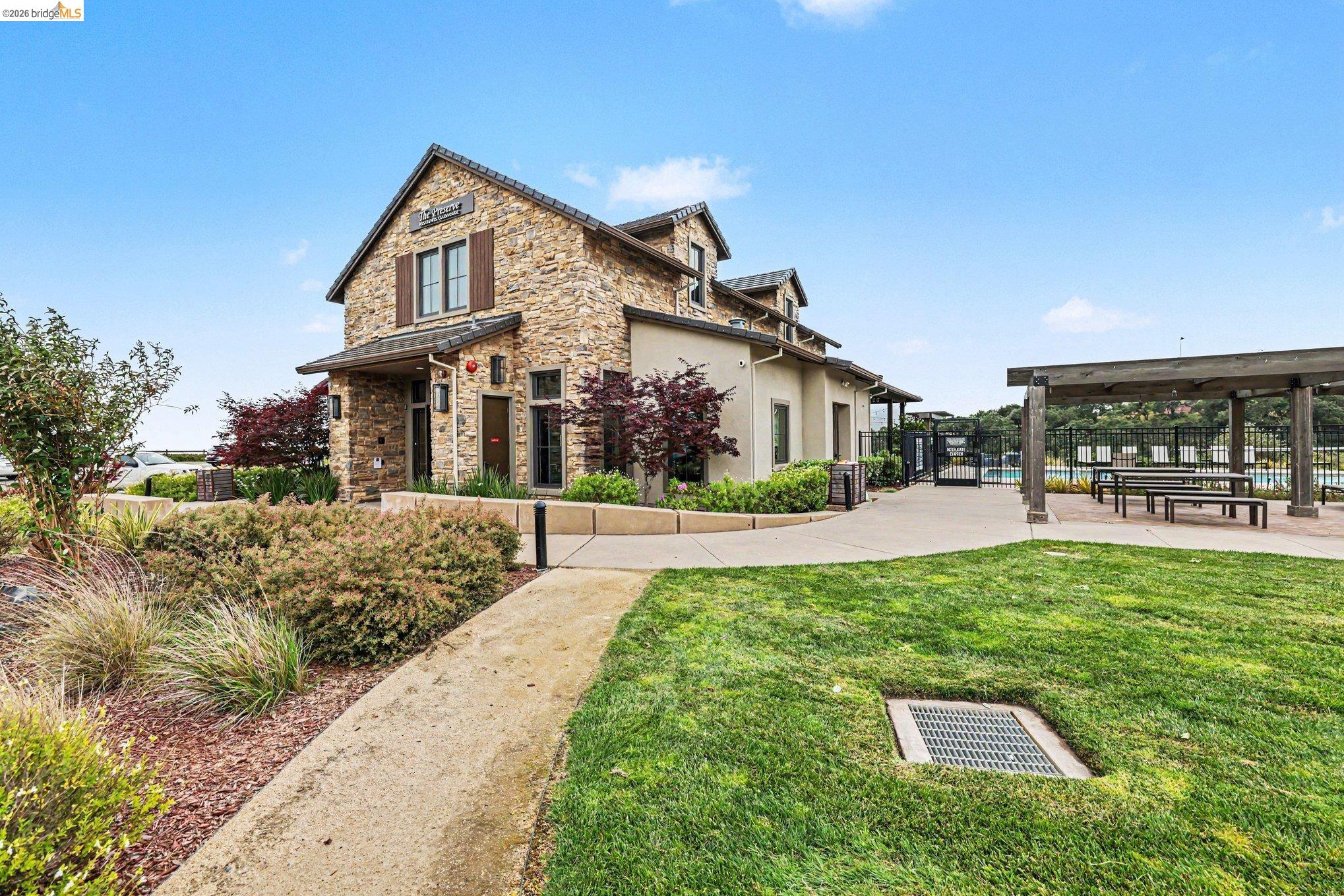 18210 Argento Loop San Ramon, CA 94583 - Photo 36 of 44 Stone-clad building with brown shutters and a prominent front entrance