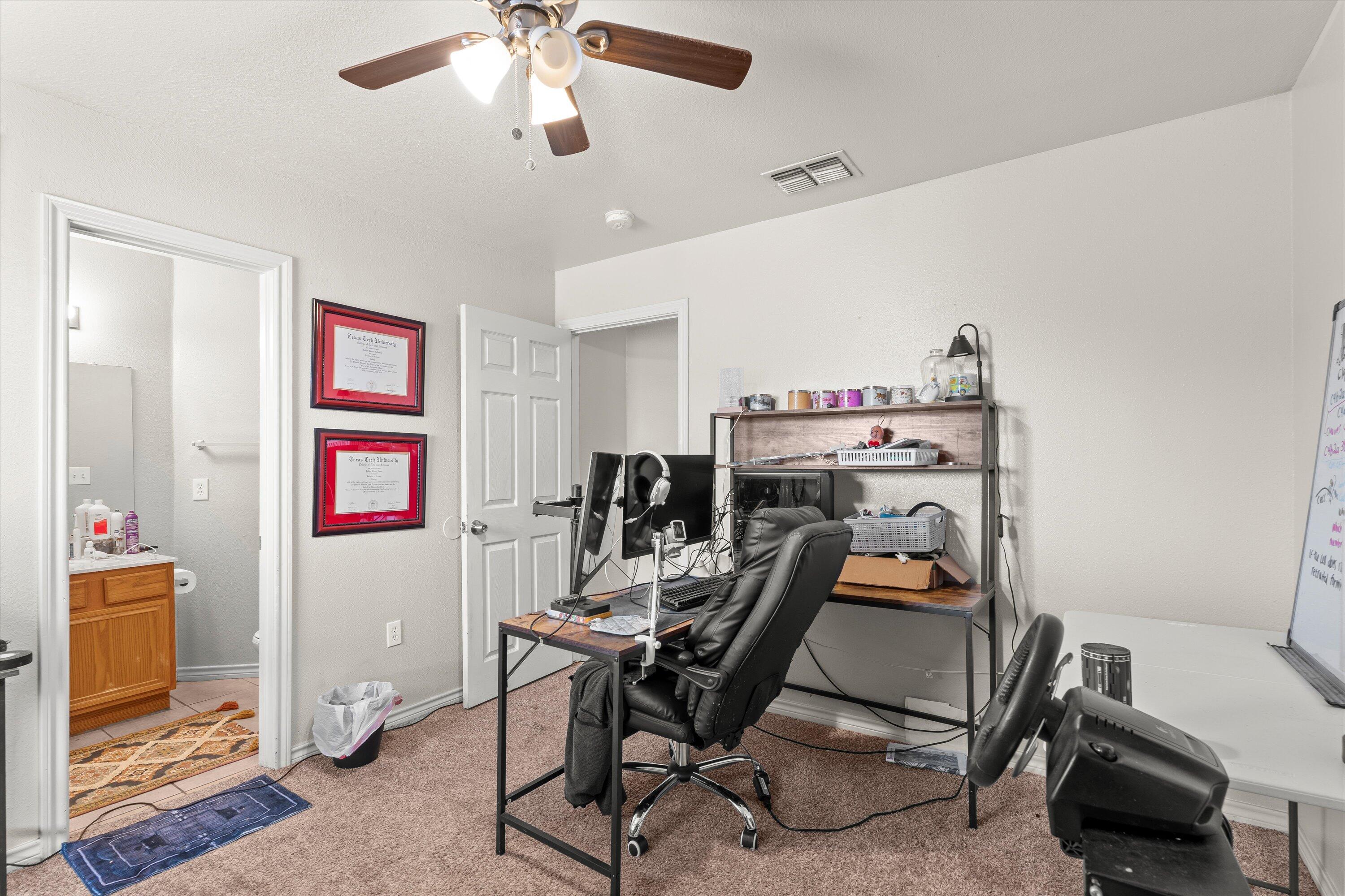 5423 Marshall Street Lubbock, TX 79416 - Photo 17 of 25 a view of a workspace with furniture and a window