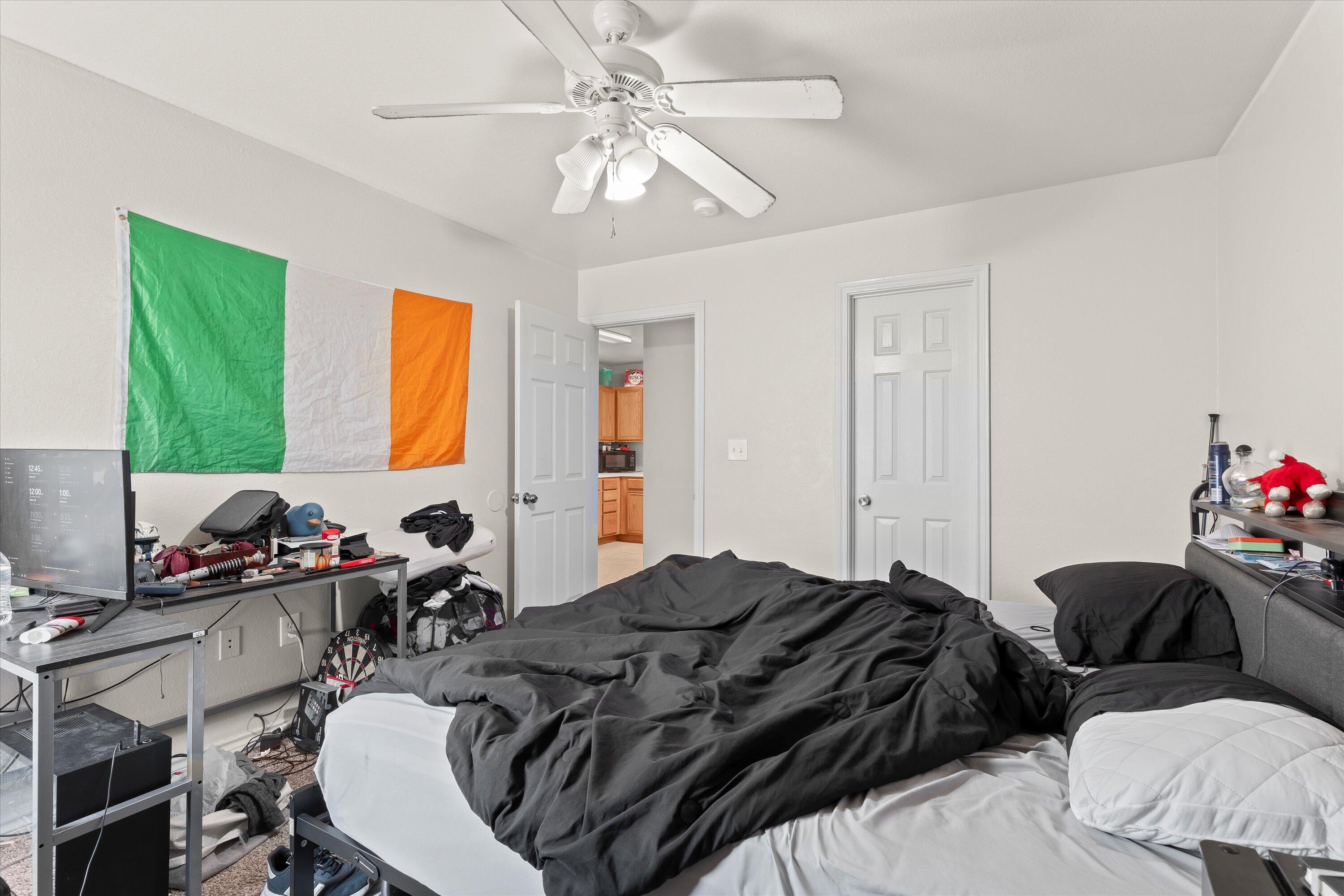 5423 Marshall Street Lubbock, TX 79416 - Photo 20 of 25 a bedroom that has a bed and a chair in it